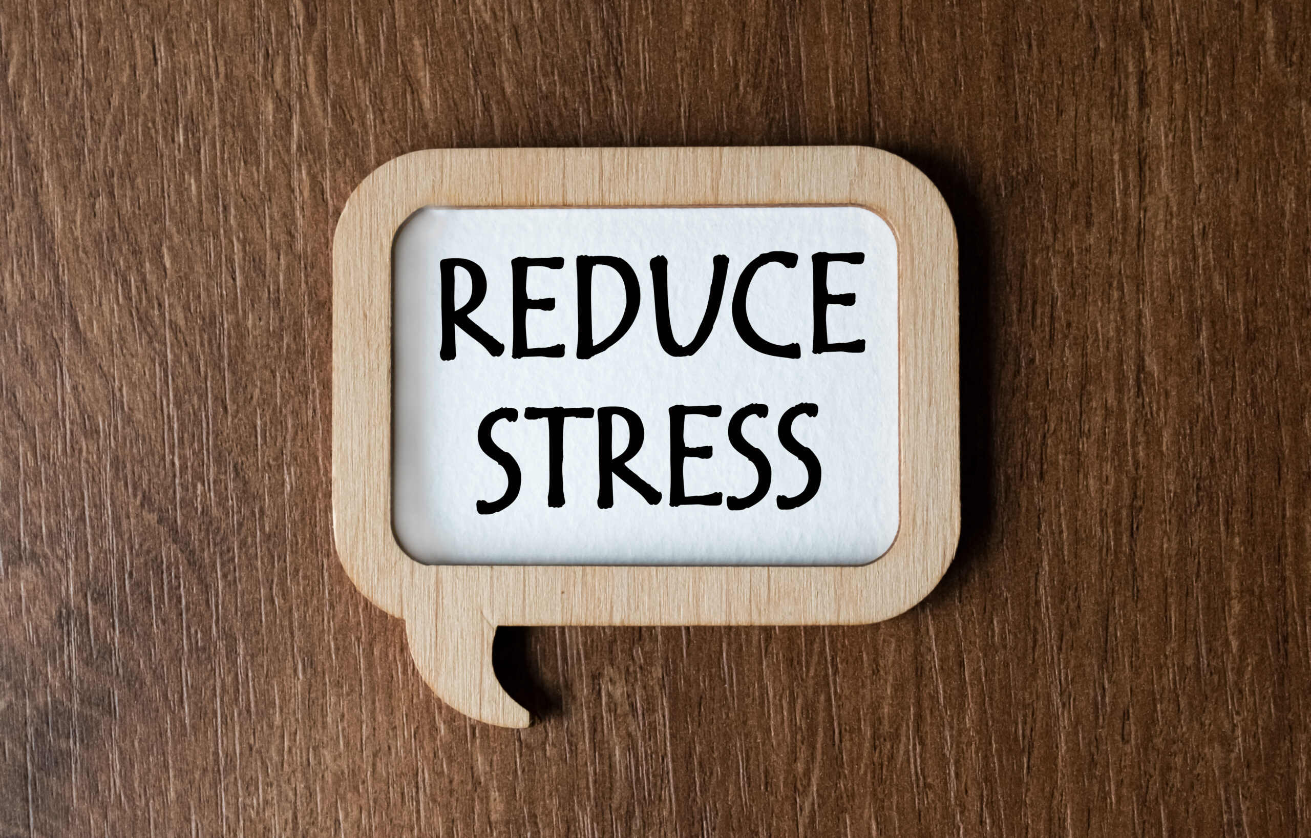 A,Wooden,Plaque,With,The,Inscription,Reduce,Stress,Lies,On